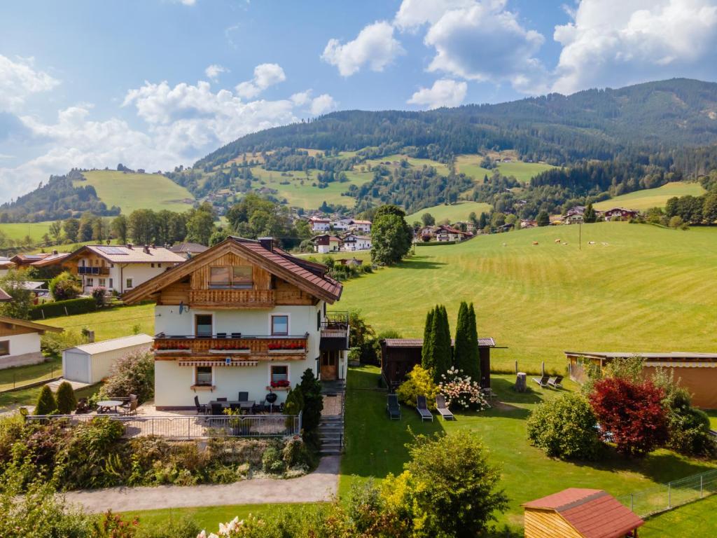 a house in a field with mountains in the background at BergHeimat in Walchen