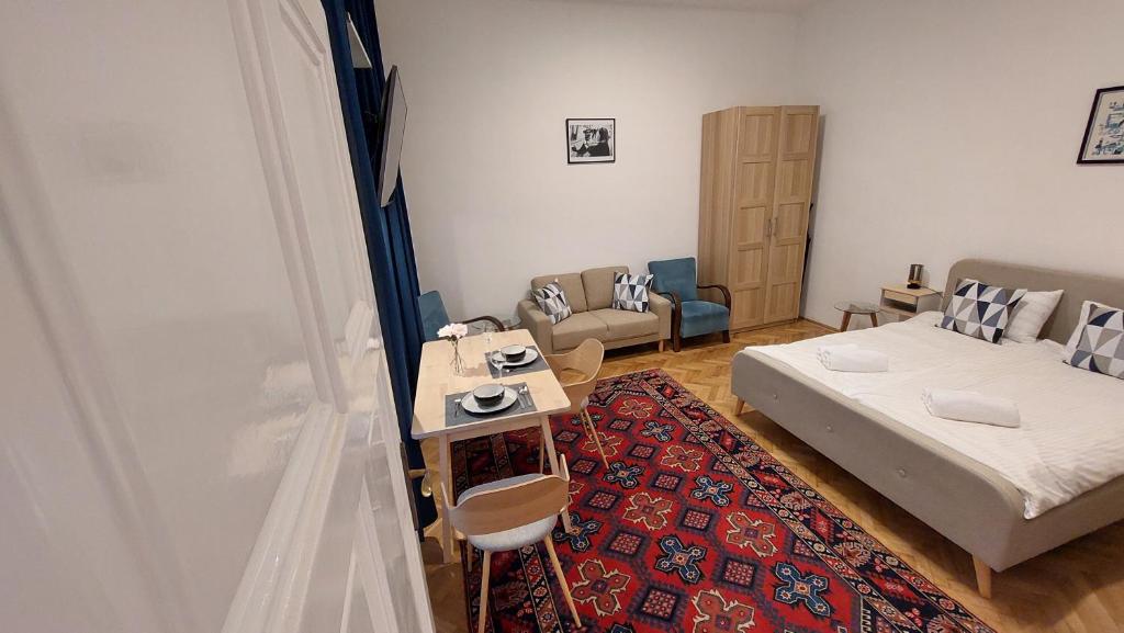 a small room with a bed and a couch at City Park Home in Budapest