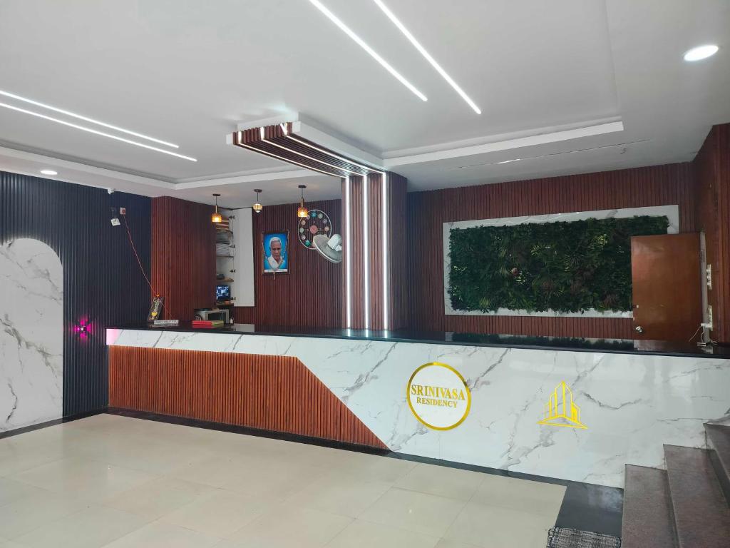 a lobby with a large marble counter in a building at SPOT ON Srinivasa Residency in Tirupati