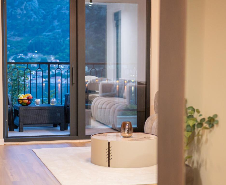 a living room with a view of a balcony at Villa Teona KotorBay Residence in Kotor