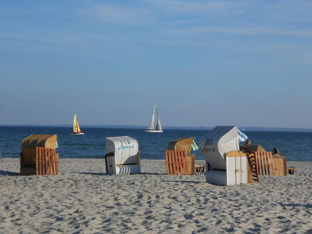 a group of beach chairs and umbrellas on the beach at Seaview & Sunside in Grömitz