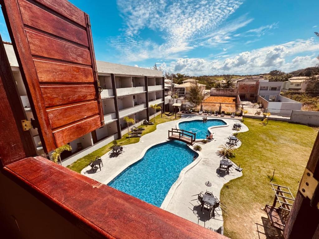 a view of a pool from a balcony of a building at Pousada Maresia Costa Azul in Rio das Ostras
