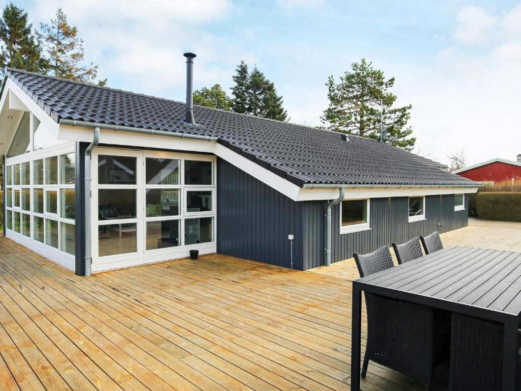 a house with a wooden deck with a patio at Luxury Retreat with Spa - By Traum Ferienwohnungen in Dannemare