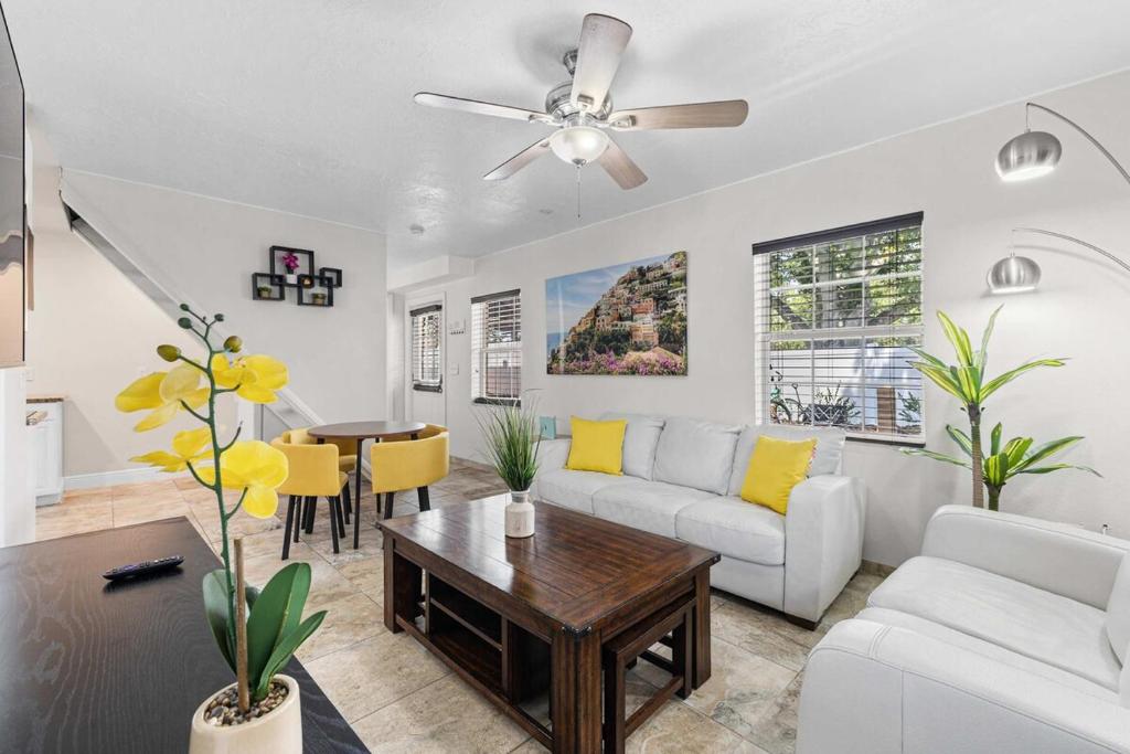 a living room with a couch and a table at Cozy 2BR - Beach & Trail - Bikes, Fire Pit in St. Petersburg