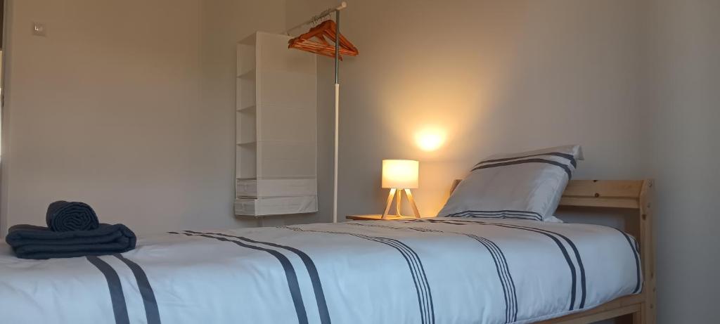 a bedroom with a bed with a lamp and a mirror at CarriCHe 2 in Lisbon