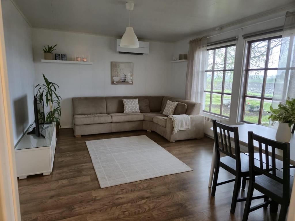 a living room with a couch and a table and chairs at Small cottage in Toholampi
