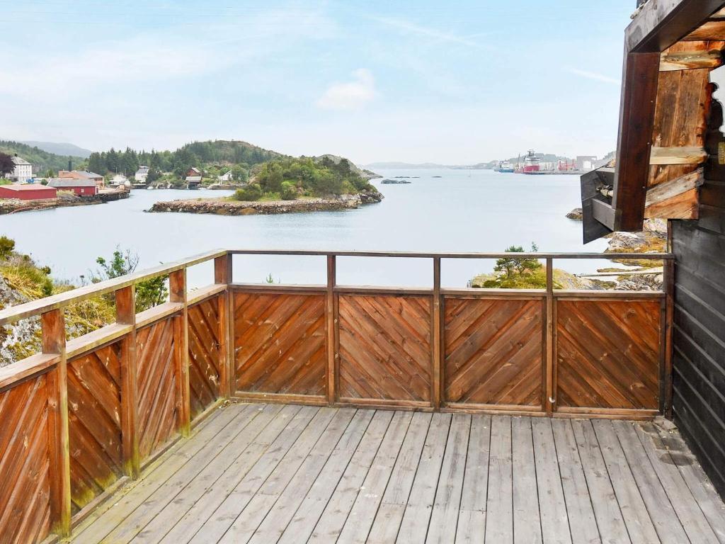 a balcony with a view of the water at 8 person holiday home in FREI in Frei