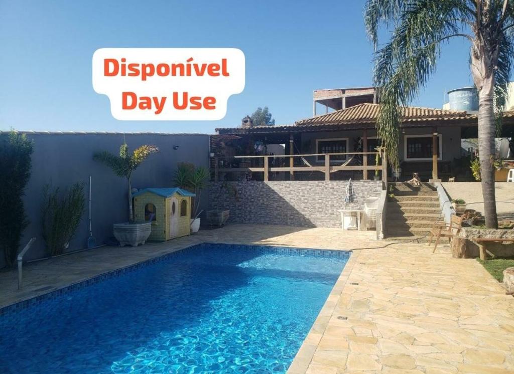 a swimming pool in front of a house at Chácara Bela Vista Mairiporã in Mairiporã