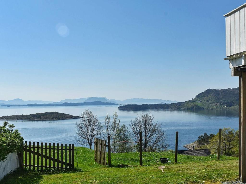 a view of a lake from a house with a fence at 6 person holiday home in Onarheim in Onarheim