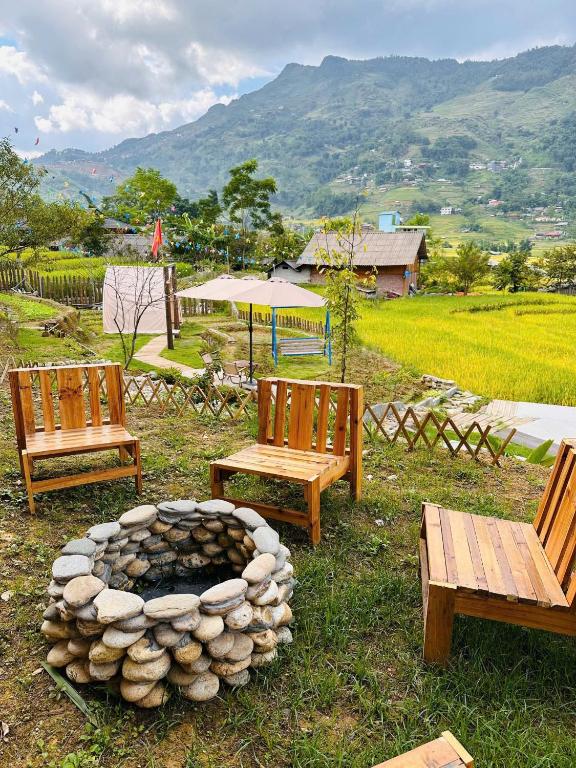 a group of benches sitting around a fire pit at Terrace House Tả Van in Sapa