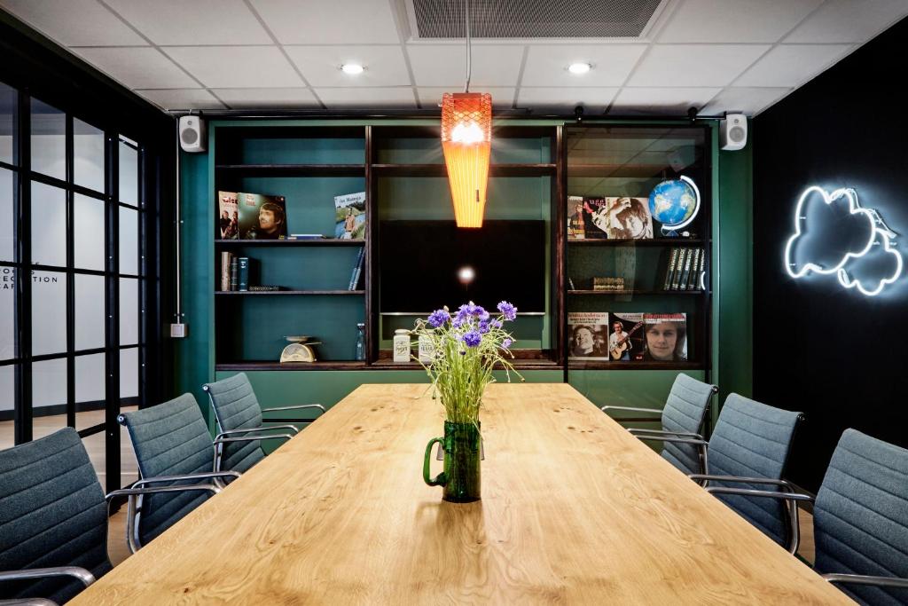 a conference room with a wooden table and chairs at Generator Stockholm in Stockholm