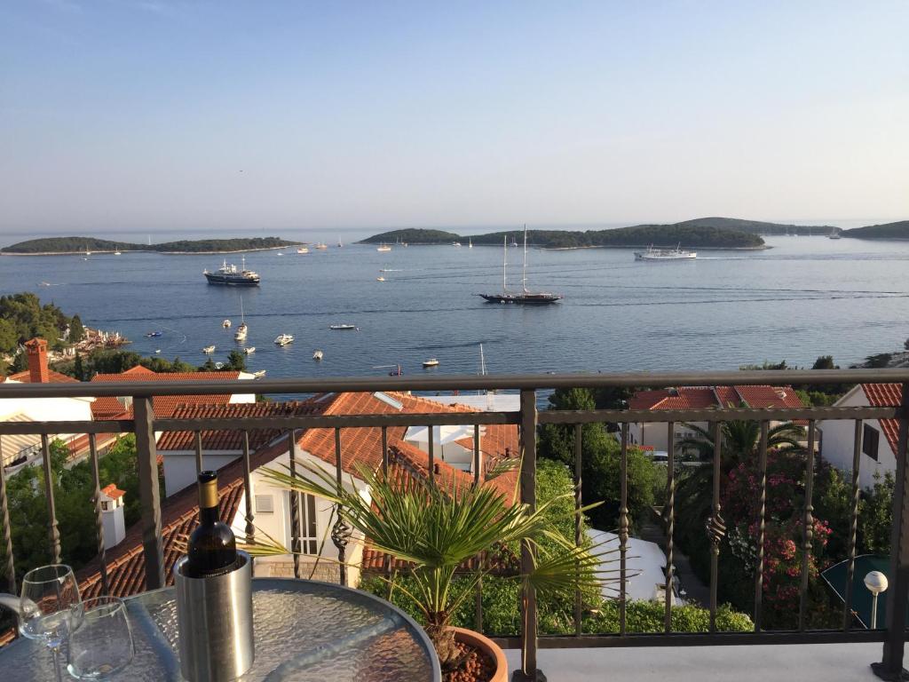 a balcony with a view of the water and boats at Top View Residence in Hvar
