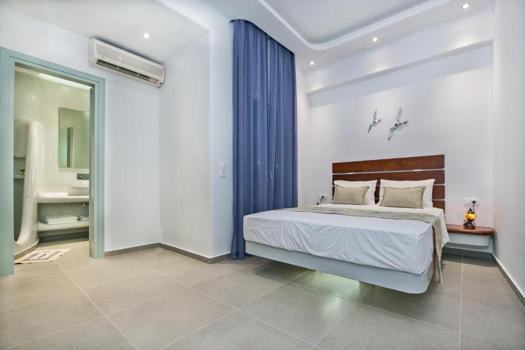 Un dormitorio con una cama grande y un baño. en Petini&#39;s Place, en Fira