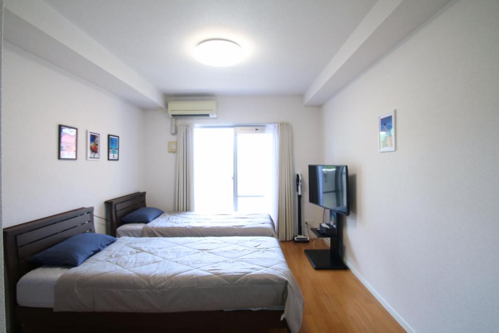 Giường trong phòng chung tại オンブラージュ九203