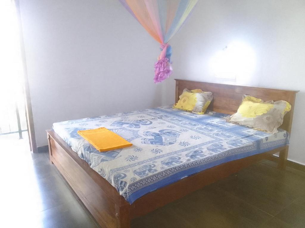 a bedroom with a bed with a book on it at Villa tharu hikkaduwa in Hikkaduwa