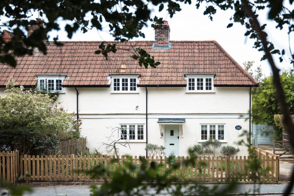 a white house with a red roof at Lavender Cottage in Burley
