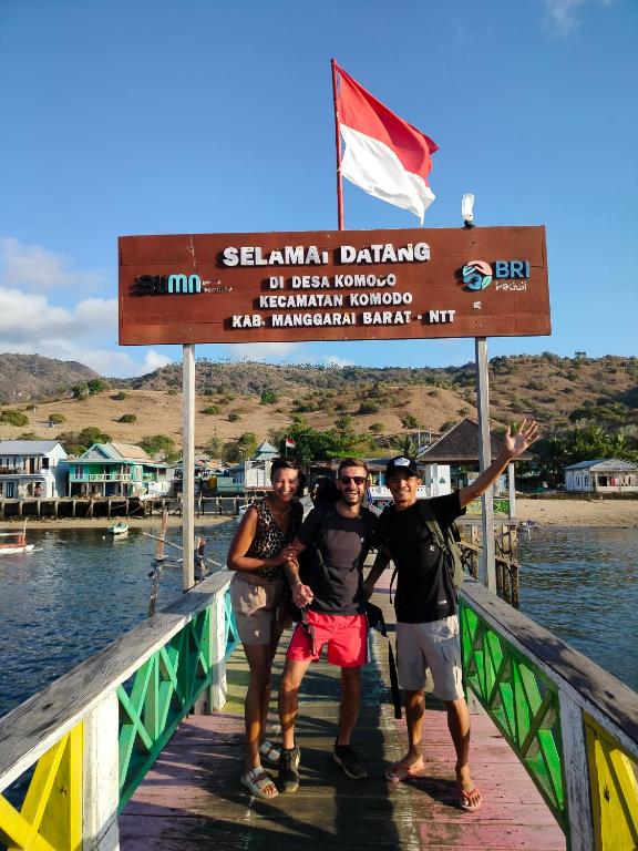 a group of three people standing on a bridge at Atta komodo homestay in Komodo