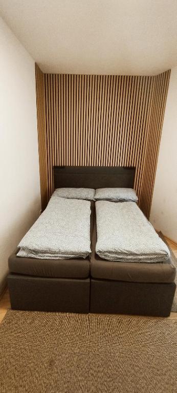 a bed in a bedroom with a headboard and two pillows at Schöne sonnige Wohnung in Jüchen