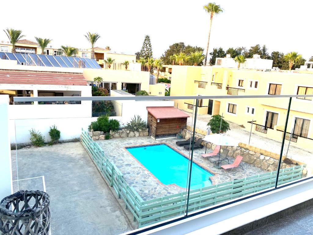 a balcony with a swimming pool on a building at Ev Zin - Modern, cozy, 1 bed, pool, 2 balconies, A105 in Nea Paphos