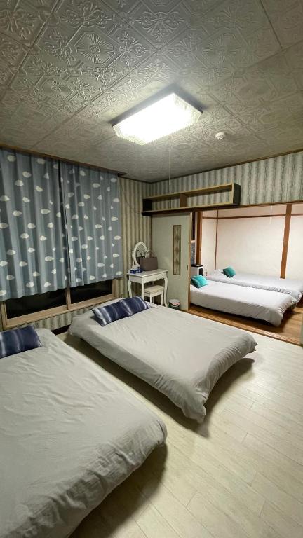 a bedroom with two beds in a room at Sound Garden Biei - Forest suite in Biei