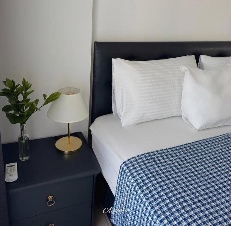 ein Schlafzimmer mit einem Bett und einer Lampe auf einem Nachttisch in der Unterkunft Ayshira Aparts in Kemer