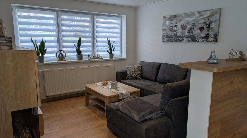 a living room with a couch and a table at Ankerplatz35 in Carolinensiel