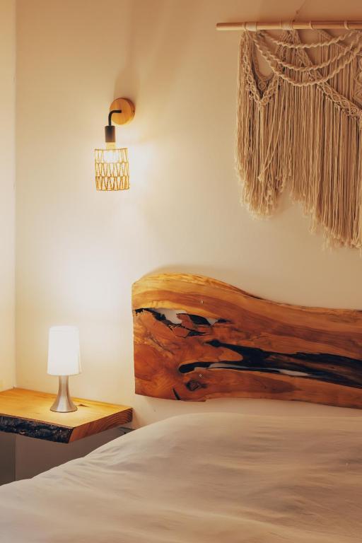 a bedroom with a bed with a painting on the wall at Aldea Molco Cabaña PEWEN in Villarrica