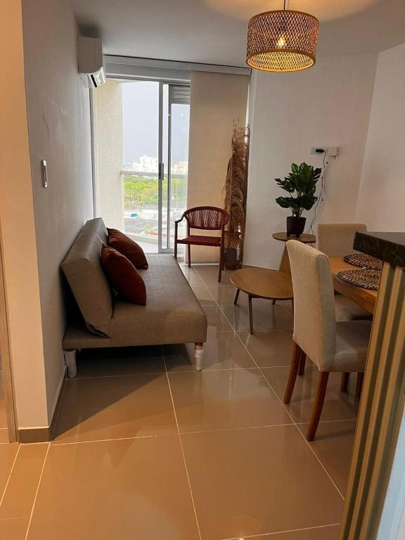a living room with a couch and chairs and a table at Vicmag House Barranquilla in Barranquilla