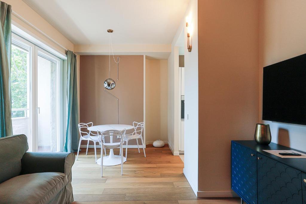 a living room with a table and chairs and a couch at MilanLife Apartments - DTown Charme in Milan