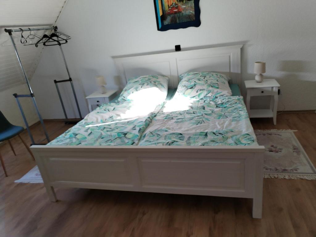 a bedroom with a bed with a white bed frame at Ferienwohnung Elena 2 in Zweibrücken