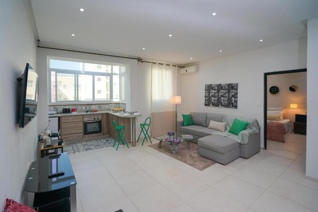 a living room with a couch and a fireplace at Luxury Fes Studio - ALHAMBRA Suites in Fès