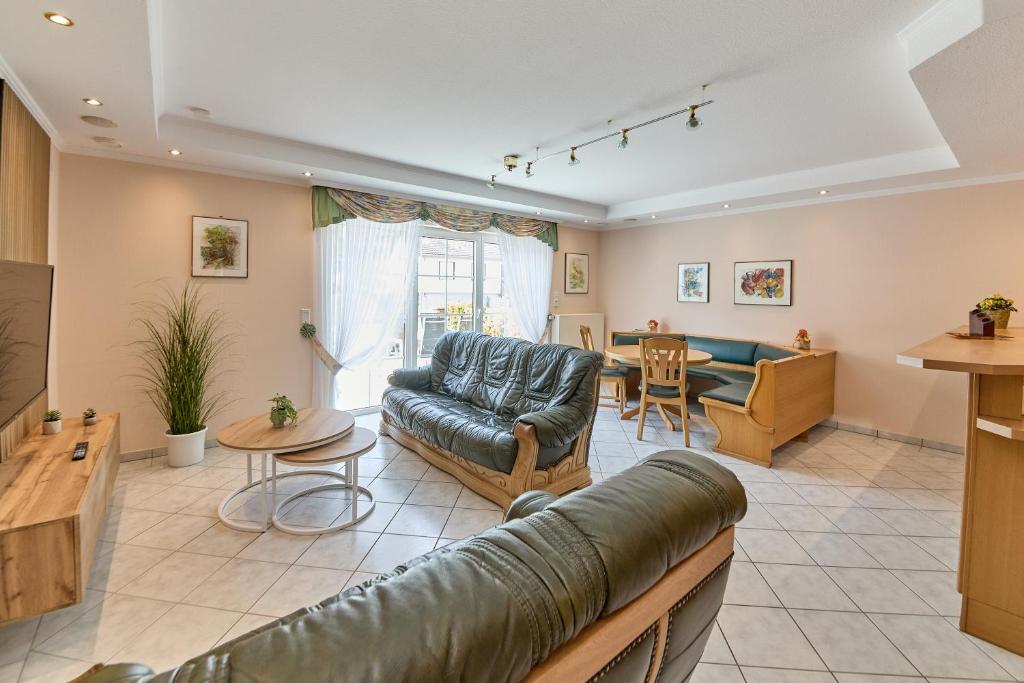 a living room with a couch and a table at Gästehaus Binz-Meyer Fewo Paulsberg in Lieser