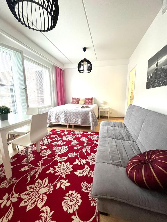 1 dormitorio con cama y alfombra roja en Scandinavian Studio Great Location, en Vantaa