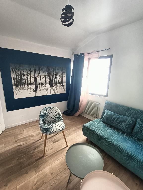 a living room with a couch and a chair at 'La forêt enchantée' in Villeurbanne