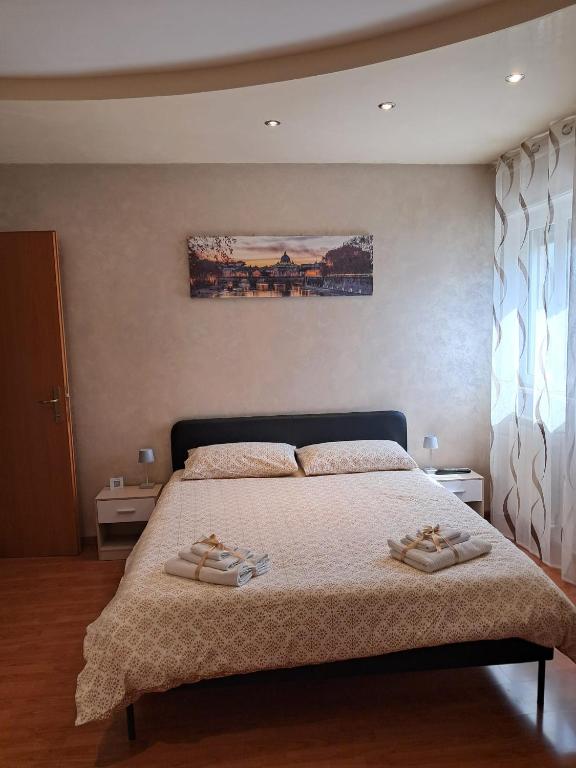 a bedroom with a bed with two slippers on it at Alloggio Turistico La Perla dell'Etruria in Sutri