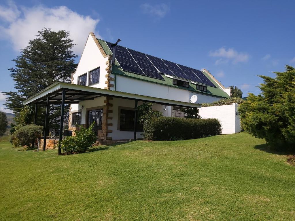 a house with solar panels on the roof at At Meerkat and Rehoboth Self Catering Lodges, Clarens in Clarens