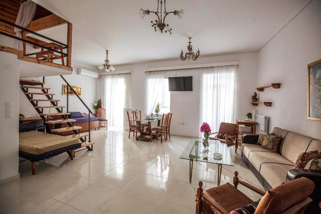 a living room with a couch and a table at Argo Luxury House in Volos