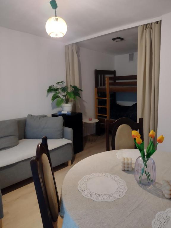 a living room with a table and a couch at Positive energy 1 in Sulejów