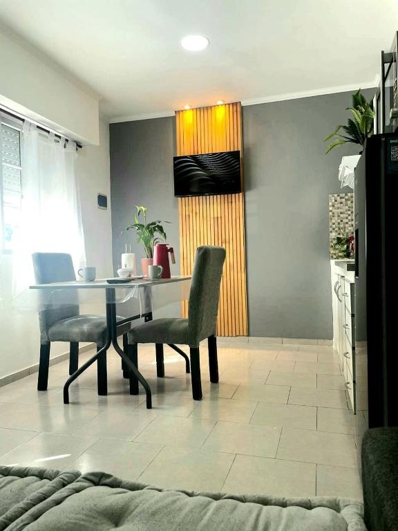 a dining room with a table and two chairs at Hospedaje Umma 3-Ezeiza in Ezeiza