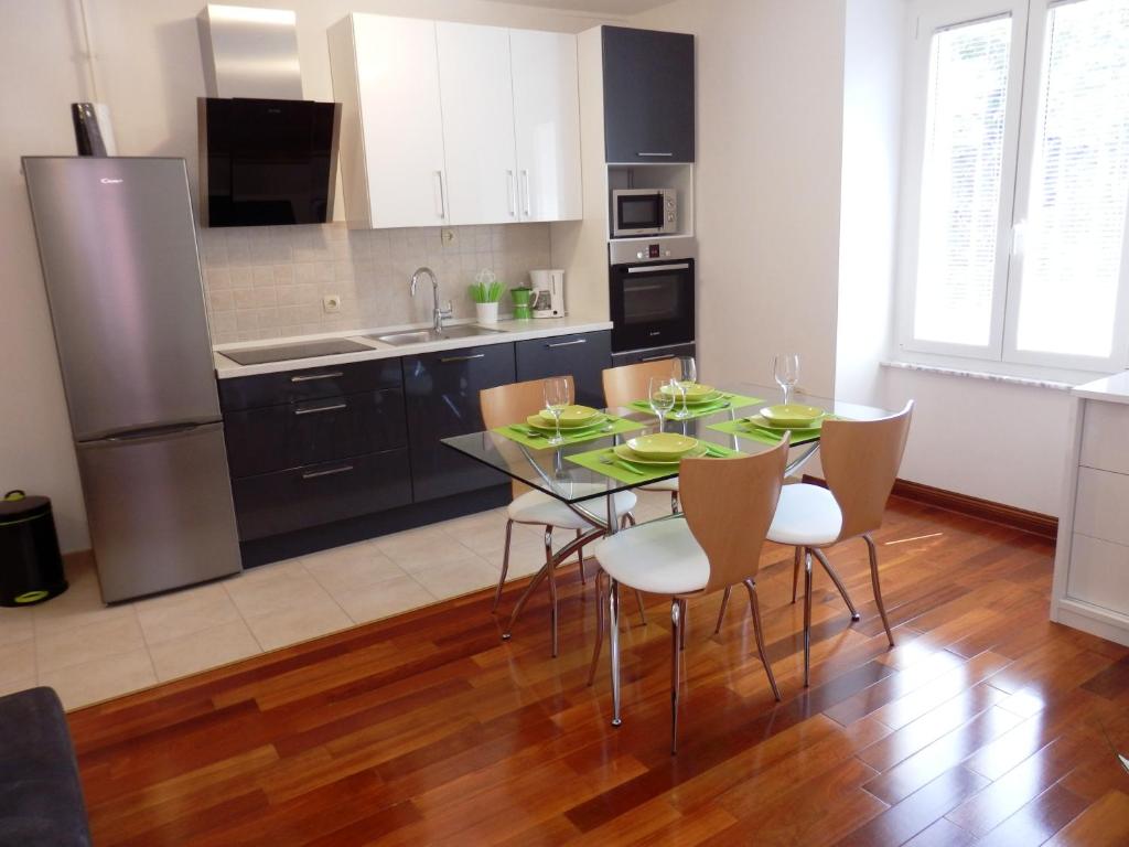 a kitchen with a dining room table and chairs at Apartment Pula Center in Pula