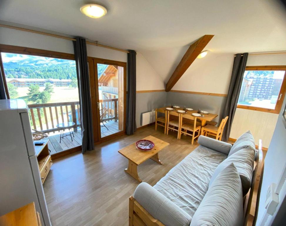 a living room with a couch and a table at Les Chalets De Superd Bleuet - APPARTEMENT 4 PIECES 8 PERSONNES EXPO SUD MAE-8824 in Le Dévoluy