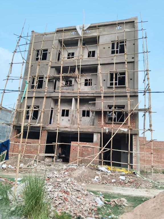 a building under construction with scaffolding around it at हर्षवाणी होम स्टे Harshvanee Home Stay in Lucknow