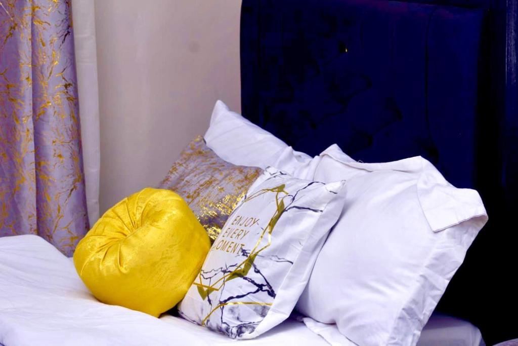 a pile of pillows sitting on top of a bed at 10 minutes to Karura forest Studios in thindigua Kiambu in Nairobi
