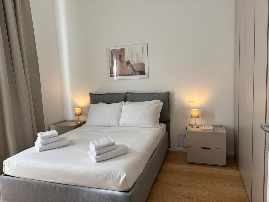 a bedroom with a bed with two towels on it at Dimora delle Vittorie - Vaticano in Rome