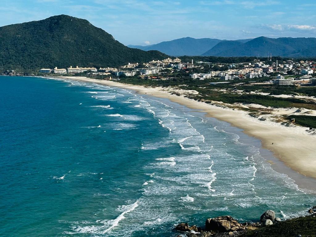 an aerial view of a beach with a city at APARTAMENTO DE PRAIA in Florianópolis