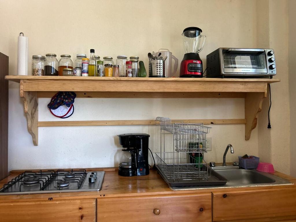 a kitchen counter with a stove and a sink at Loft Maloqueña - Balcony - Full Kitchen - 3 Beds in Brisas de Zicatela