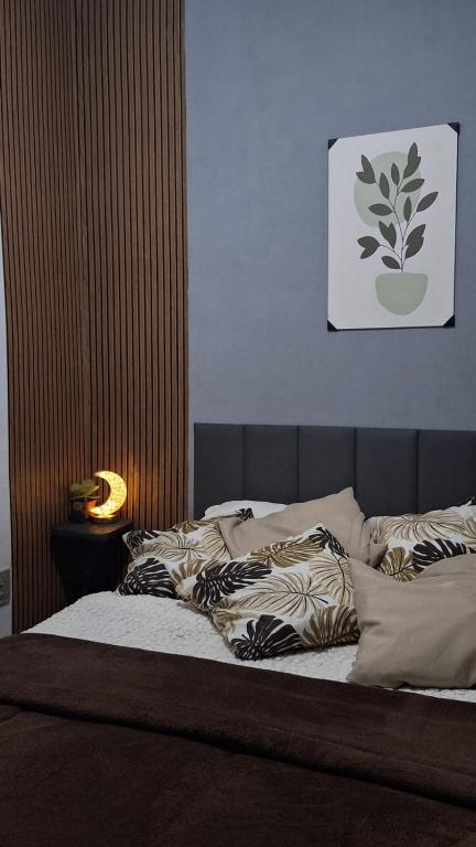 a bed with pillows on it in a bedroom at RustiCity in São Paulo