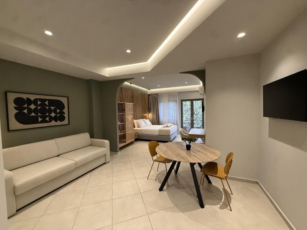 a living room with a couch and a table at Chanioporta suites in Heraklio
