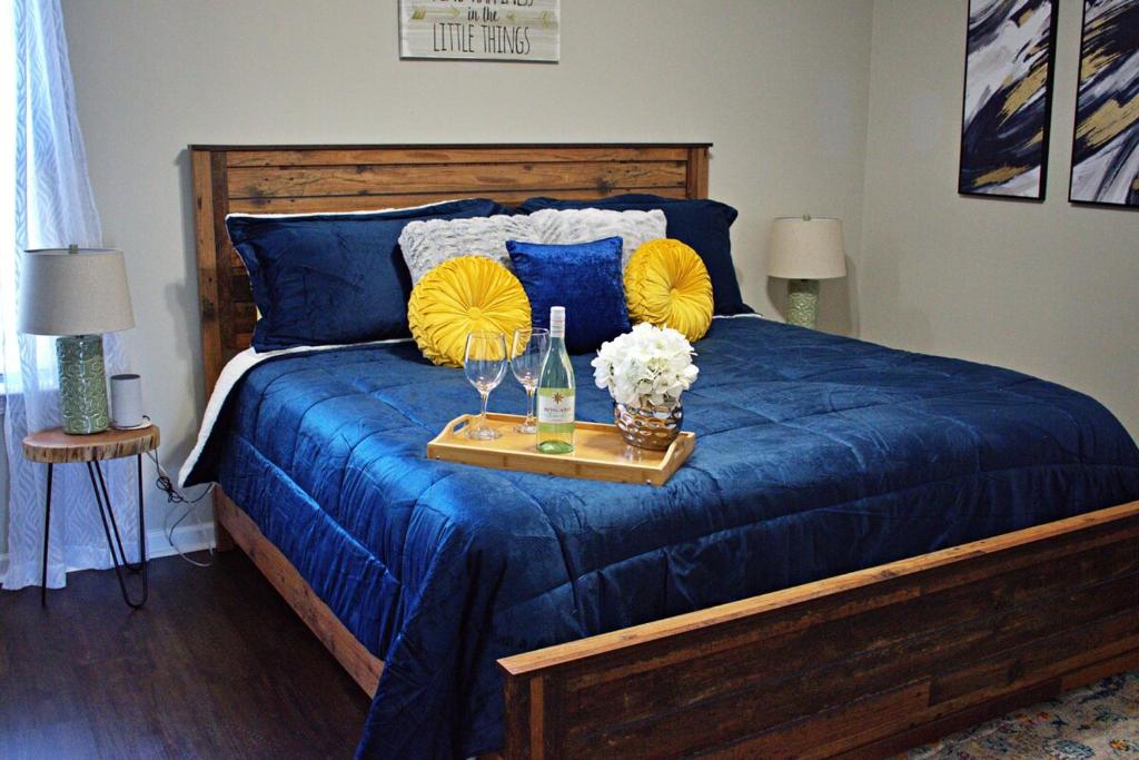 a blue bed with a tray with flowers on it at Lg Deck-BBQ Grill - King Suite - Near RAFB in Bonaire