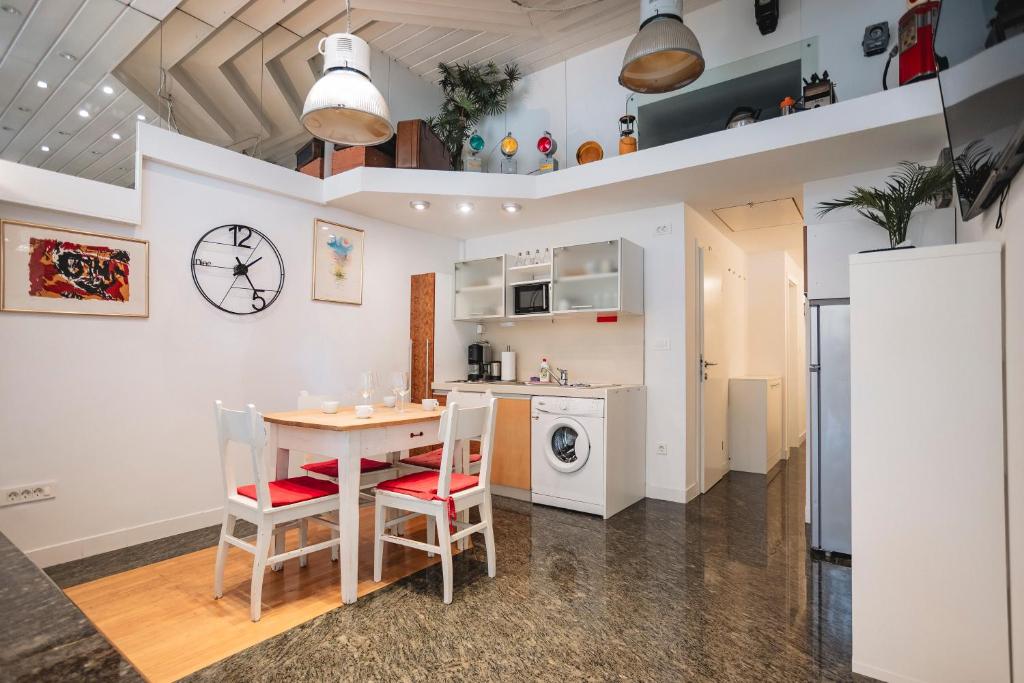 a kitchen and dining room with a table and chairs at LightBox Central in Ljubljana